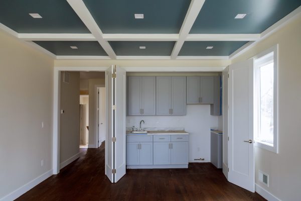 Interior design construction of passover kitchen with cabinet maker installing custom